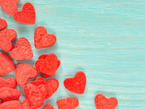 Candy heart confetti on blue wooden background. Copy space. Top view or flat lay. Close up