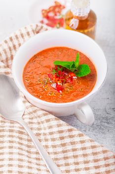 Bowl of fresh tomato soup gazpacho on a napkin.