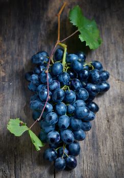 Bunch of red grapes on wooden table background