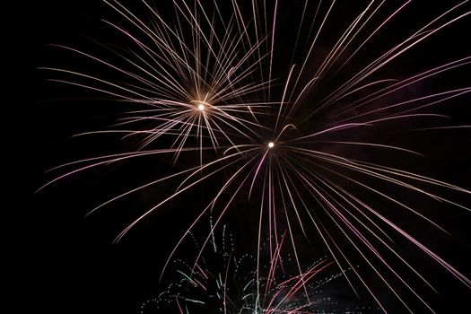 Colorful fireworks explosion in a dark night