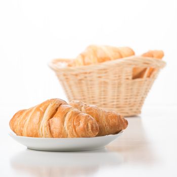 Fresh baked croissants against a white background.