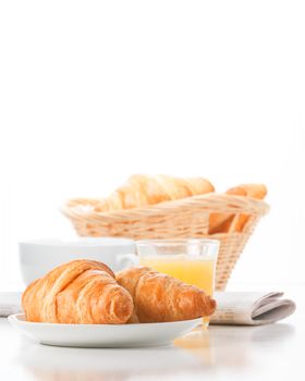 Fresh baked croissants served with coffee and juice.