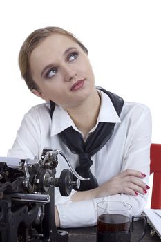 Young girl typist with an old typewriter on a white background