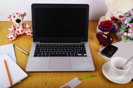 Mock up objects such as computer, smartphone on a wooden background, front view