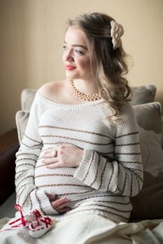 Portrait of a pregnant woman in the room