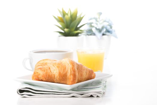 Fresh croissants served with coffee and orange juice.