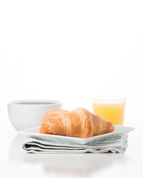 Fresh croissants served with coffee and orange juice.