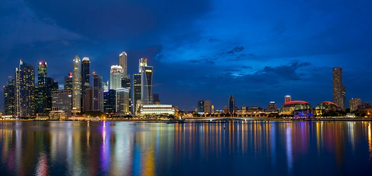 Singapore Central Business District Skyline by Marina Bay during Evening Twilight Blue Hour Panorama