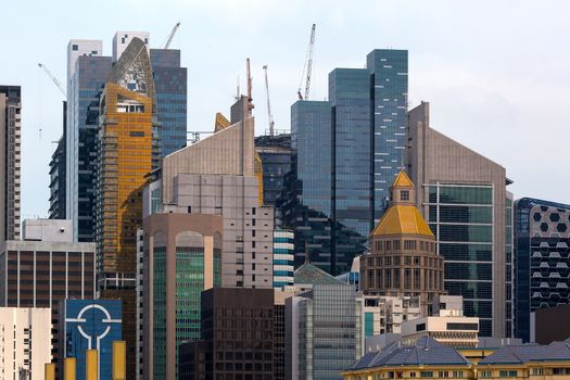 Singapore modern office buildings skyscrapers with construction cranes