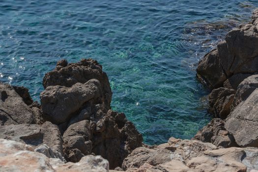 Small rocks in the blue Mediterranean Sea on Majorca's coast.