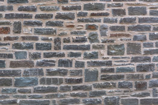 Background, old broken stone wall with relief texture and shadows.