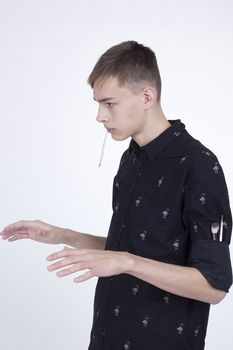 Young man makeup artist at work on a white background