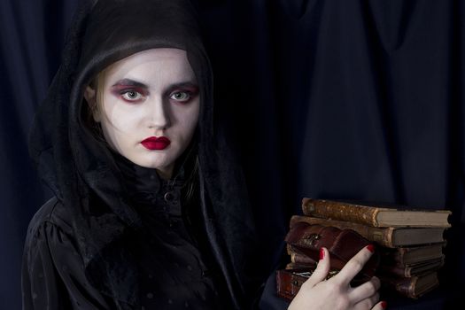 Young girl vampire on a black background