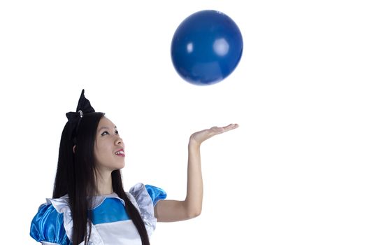 Young girl in the image of Alice with blue ball