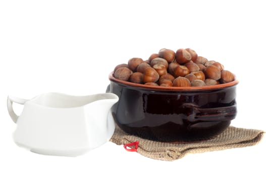 some hazelnuts placed over a white background