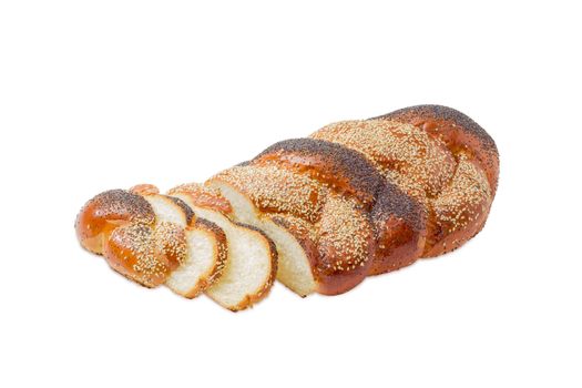 Partially sliced braided bun dusted by poppy seeds and sesame seeds on a light background
