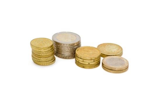 Several stacked euro coins from 10 to 50 cents, and in denominations of 1 and 2 euro on a light background
