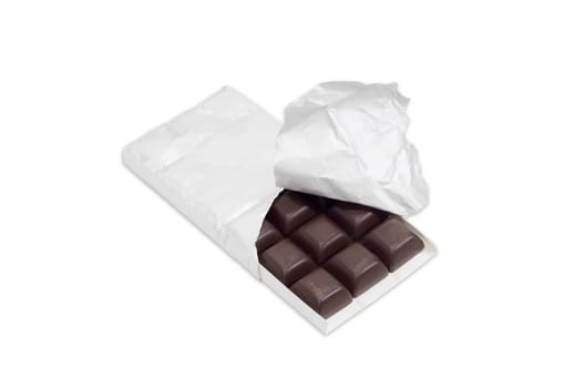 Slices of dark chocolate in the opened packaging made of foil on a light background
