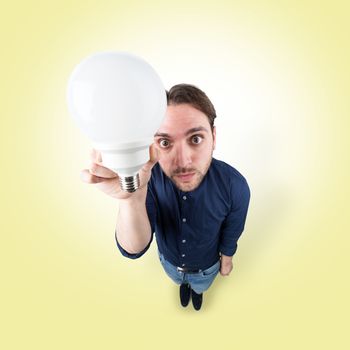  Funny young man with light bulb in his hand from above