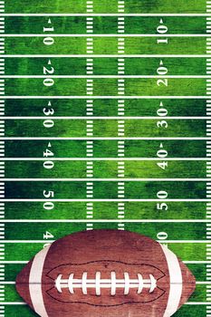 A retro grunge American football field and ball background illustration.