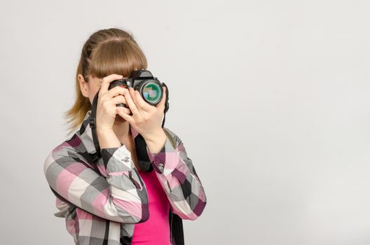 Portrait of a girl the photographer photographing camera