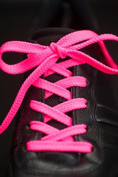 pink lacing on man sport black sneaker