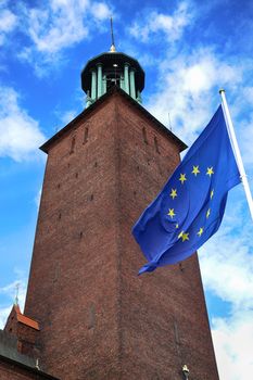 Stockholm City Hall ( Stockholms stadshus) with EU flag in Stockholm, Sweden