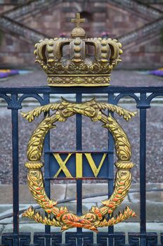 The fence of the Royal Palace with crown in Stockholm, Sweden