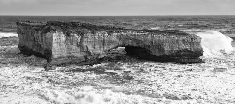 View of the London Bridge on Great Ocean Road during the day. Black and White.