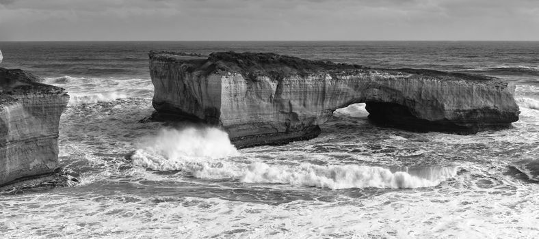 View of the London Bridge on Great Ocean Road during the day. Black and White.