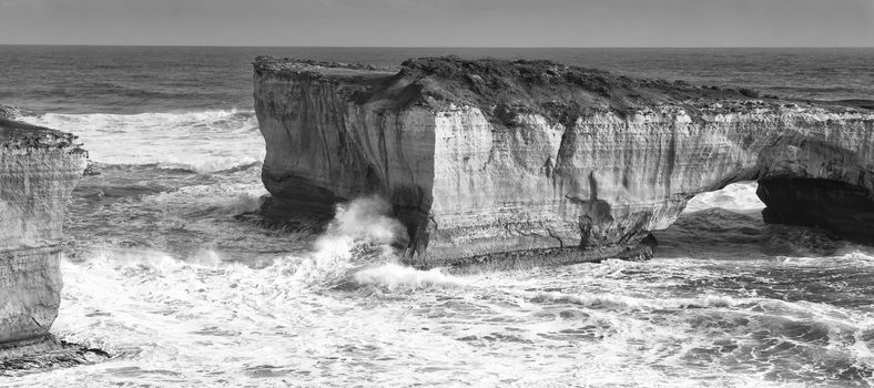 View of the London Bridge on Great Ocean Road during the day. Black and White.