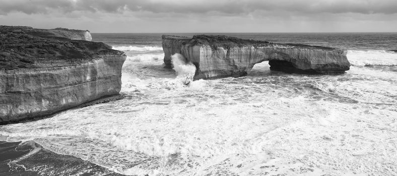 View of the London Bridge on Great Ocean Road during the day. Black and White.