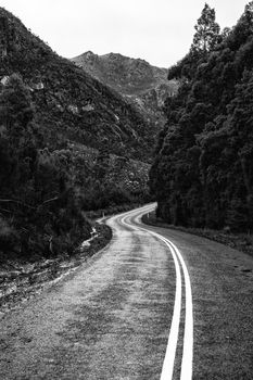Road and mountains out in the Tasmanian country during winter on a rainy day. Black and White.