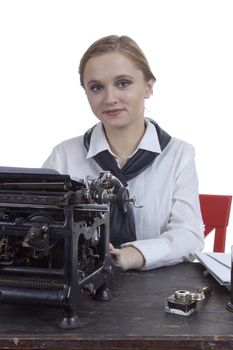 Young girl typist with an old typewriter on a white background