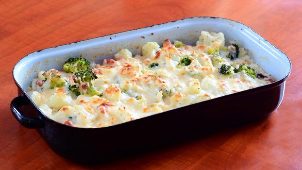 Cauliflower and broccoli with grated parmesan baked in black pan.