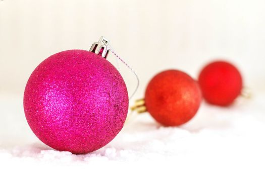 Magenta ball on the ice in winter.