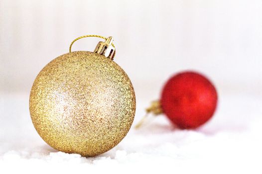 Golden ball on the ice in winter.