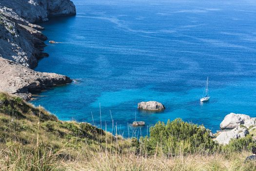 Picturesque sea landscape with bay and sailing ship on Mallorca, Baleares in Spain.