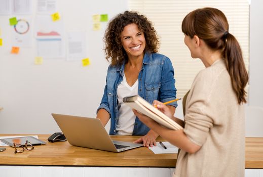 Shot of two businesswoman working together in an office