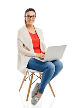 Beautiful and happy woman working with a laptop, isolated over white background 