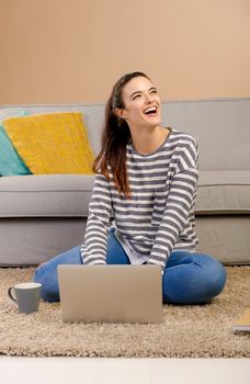 Beautiful woman at home working with a laptop