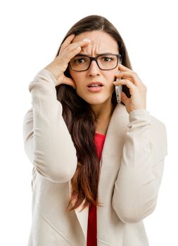 Stressed woman talking on the phone, isolated over white background