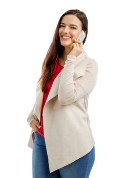 Beautiful woman talking on the phone, isolated over white background