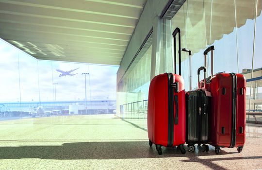 stack of traveling luggage in airport terminal and passenger plane flying for air transport and treveling theme