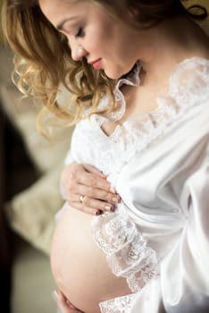 Portrait of a pregnant woman in the room