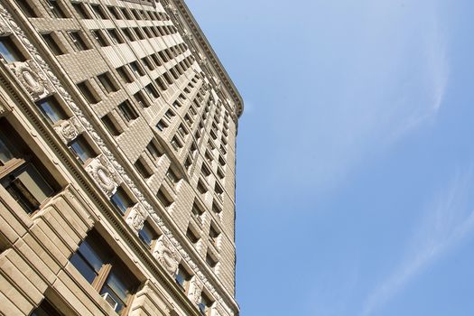 New York, USA, november 2016: Flat Iron building viewed from the bottom. Completed in 1902, it is considered to be one of the first skyscrapers ever built.