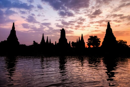 Landscape silhouette of Wat Chaiwatthanaram during sunset next to the Chao Phraya River is ancient temple famous religious attraction of Ayutthaya Historical Park, Thailand