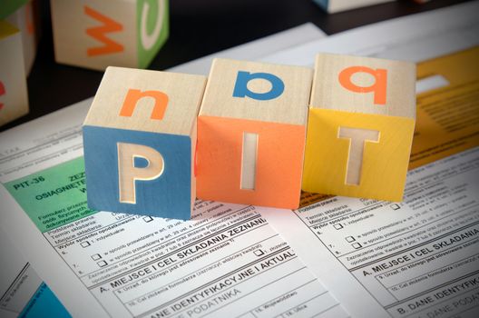 PIT word with colorful blocks. polish tax form money business finance block concept