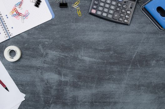 Business desk in office top view. Table with calculator, notepad, and office supplies. Copy space website banner concept