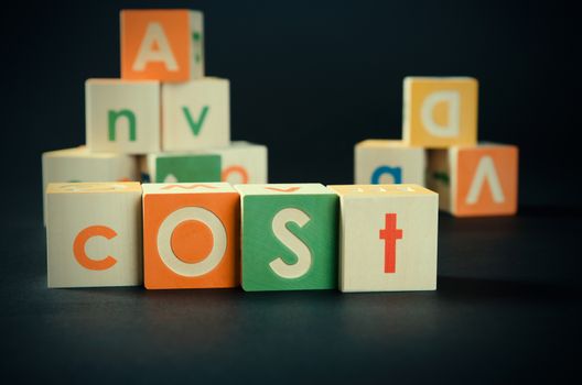 COST word with colorful blocks. cost accounting business blocks alphabet analysis concept